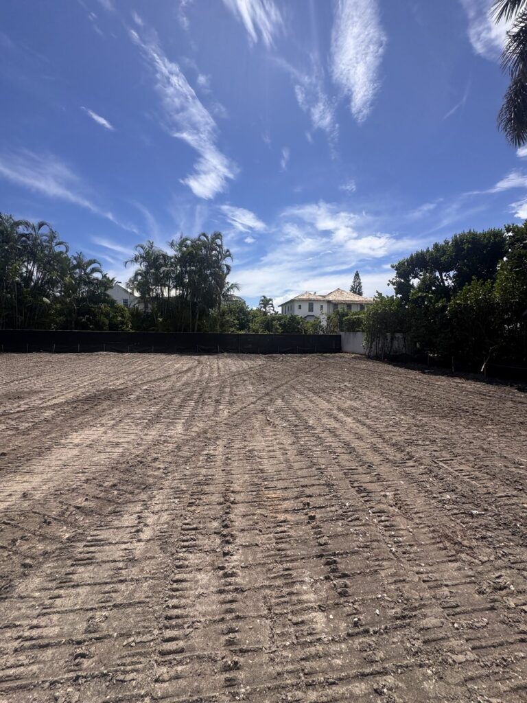 Cleared and graded building pad after full site clearing and debris haul off, ready for the next trade to start.